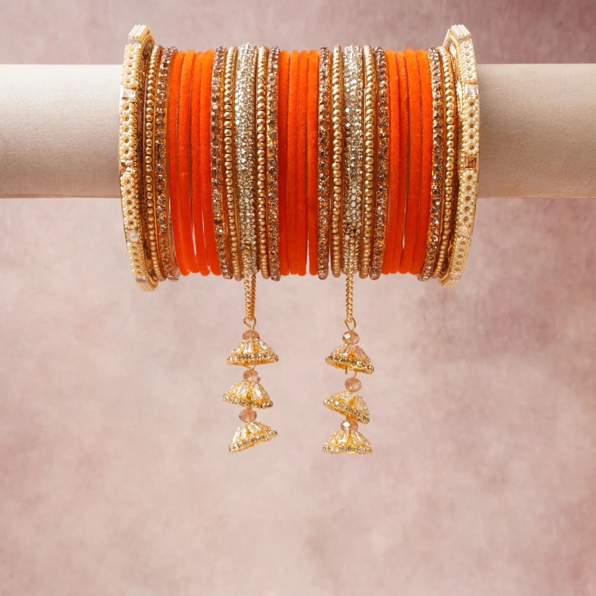 A grounding Orange forms the heart of the set, while touches of Gold, Clear, Cream add charm.

A thoughtful composition of Velvet, Gold-toned metal, Rhinestones, Pearl beads, designed to feel complete without being heavy.
Each element layers seamlessly, creating a look that is refined, wearable and quietly striking.